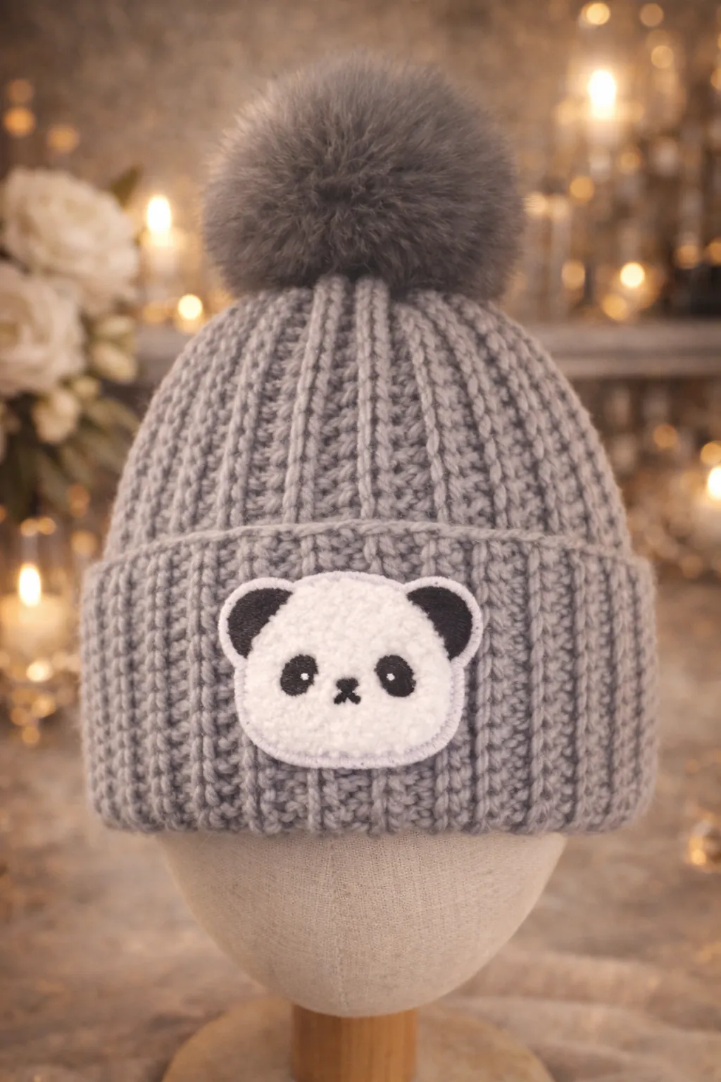 Grey ribbed baby beanie with a panda face.