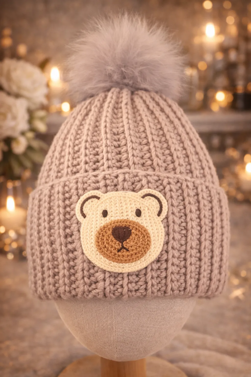 Oatmeal baby beanie with an owl patch.