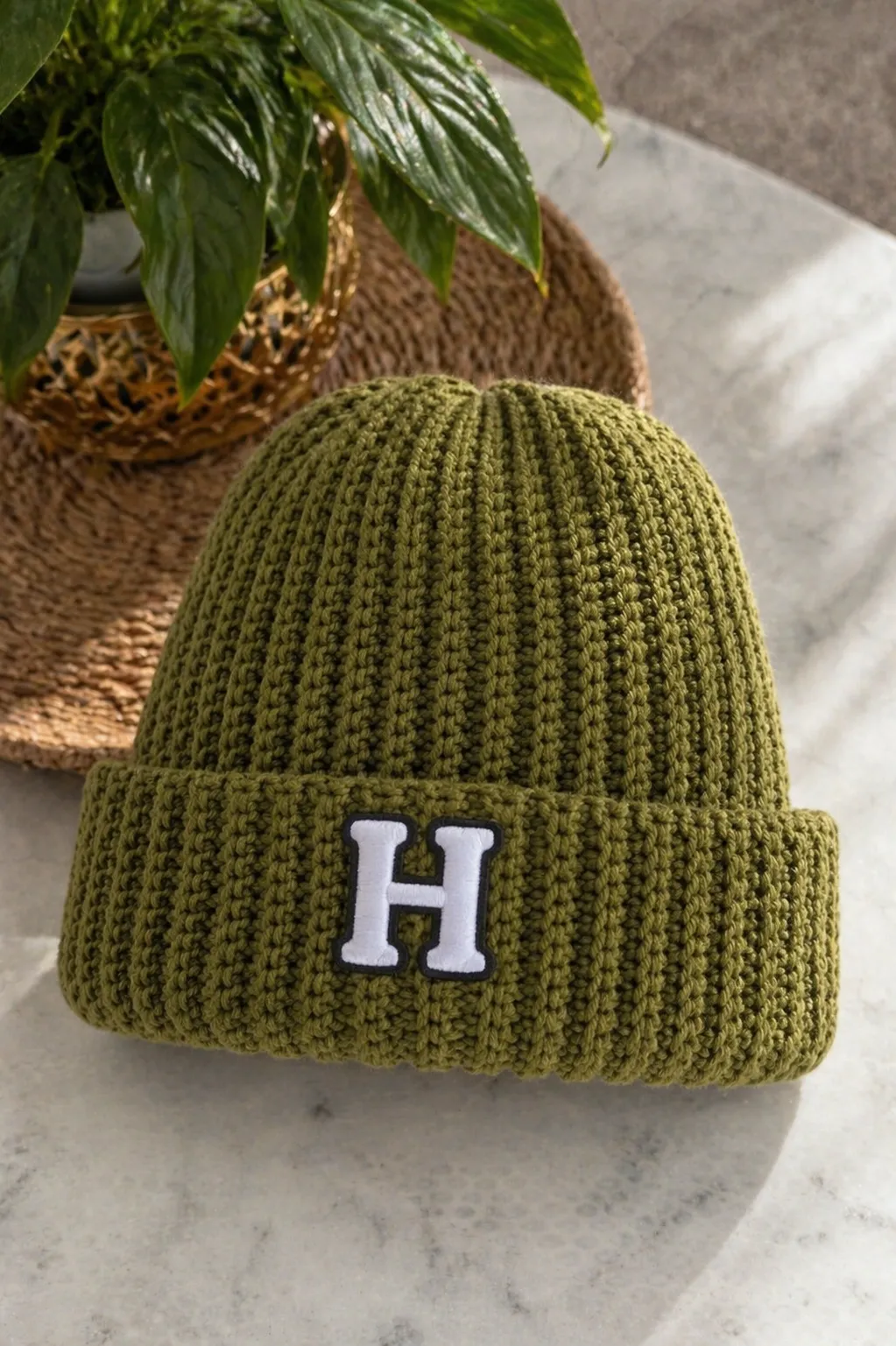 Superhero green crocheted ribbed beanie with white H patch